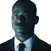 a man in a suit and tie with a serious look on his face