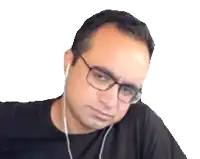 a man wearing glasses and ear buds looks sad
