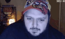 a man wearing a superman hat is looking at the camera