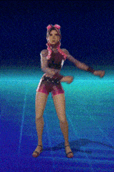 a woman in pink shorts and a black top is dancing on a blue background .