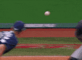a blurred image of a baseball game with a catcher catching a ball