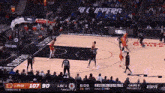 a basketball game is underway with the score 107-90