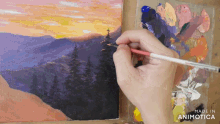 a person is painting a landscape with the words made in animotica below