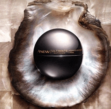 a black bottle of anew ultimate supreme creme is sitting on top of an oyster shell .