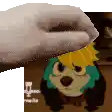 a hand is holding a towel over a cartoon dog with green hair and glasses .