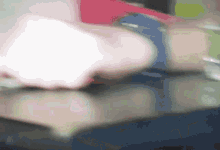 a blurry picture of a person 's arm with a blue watch
