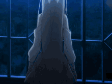 a girl with long white hair is standing in front of a blue wall
