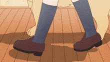 a close up of a person 's feet with a dog behind them