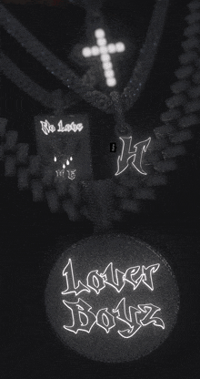 a lover boyz necklace with a cross pendant