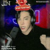 a man wearing headphones with a sign that says big love on it