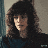a close up of a woman 's face with netflix written on the bottom