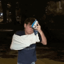 a man wearing a shirt that says wycomb is holding a bag of ice cream