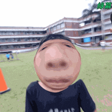 a person making a funny face in front of a building with chinese characters on it
