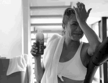 a woman holding a bottle of collagen water in her hand