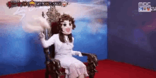 a woman in a white dress is sitting in a chair with a mask on her face .
