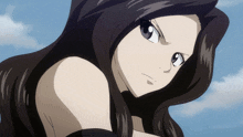 a close up of a girl 's face with a blue sky behind her