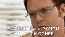 a man wearing glasses is talking on a cell phone and saying we going to stay mad with each other .