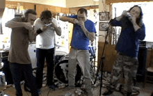 a man in a blue shirt is playing a flute