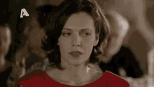 a woman in a red dress with the letter a on the bottom right