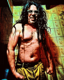 a shirtless man with long hair and sunglasses smiles