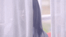 a woman with long purple hair and a choker looks at the camera
