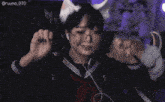 a girl wearing glasses and a cat ear headband has the number 070 on the bottom right