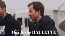 a man says " moi je dis raclette " while another man looks on