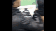 a blurry picture of a person 's back with a white object in the background
