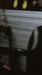 a blurry image of a person standing in front of a wall