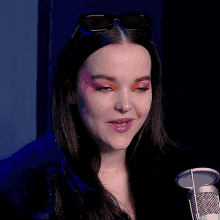 a close up of a woman 's face with a microphone in the foreground