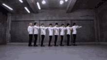 a group of young men are standing in a row