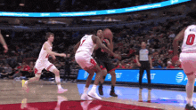 a basketball player with the number 0 on his jersey dribbles the ball