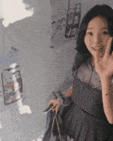 a woman in a pleated skirt is giving a thumbs up sign