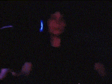 a pixel art of a person holding a microphone in a dark room