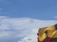 a person in a yellow and red jacket is skiing down a snow covered mountain .