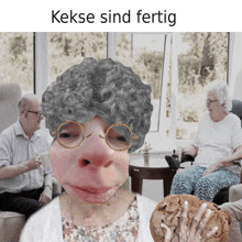 a picture of an elderly woman with glasses holding a cookie with the caption kekse sind fertig