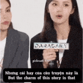 a woman is holding a microphone in front of a sign that says daradaily .