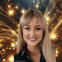 a woman with a key necklace smiles in front of a gold background