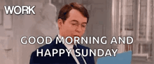 a man in a suit and tie is saying `` work good morning and happy sunday '' while holding a clipboard .