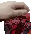 a close up of a person 's hand holding a piece of paper in front of a picture of a group of people .