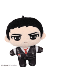 a stuffed doll of a man in a suit and tie with a badge on his chest