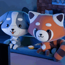a dog and a red panda are sitting on a couch