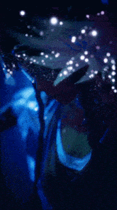 a person 's face is visible in a blurry photo with a blue background