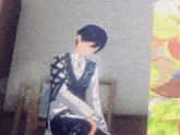 a man in a suit is sitting on a chair next to a painting of flowers .