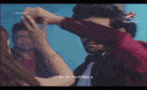 a man in a red shirt is being touched by a woman in a star plus advertisement