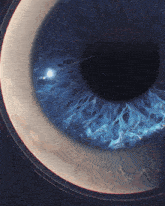 a close up of a blue eye with a white crescent moon in the background