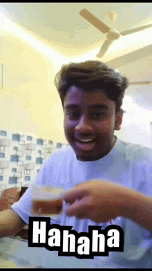 a man in a white shirt is holding a glass with the word ' hahaha ' on the bottom right