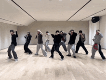 a group of people are dancing in a room with a skateboard on the floor