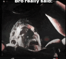 a man with blood on his face is screaming into a microphone with a caption that reads bro reality said