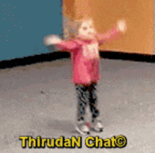 a little girl in a pink jacket is dancing in a room with the words thiruda chat written on the bottom